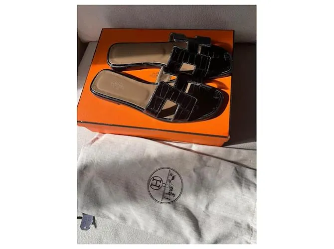 Oran Hermès Sandalias abiertas Negro 
