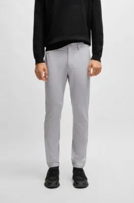 Pantalones slim fit en tejido elástico repelente al agua