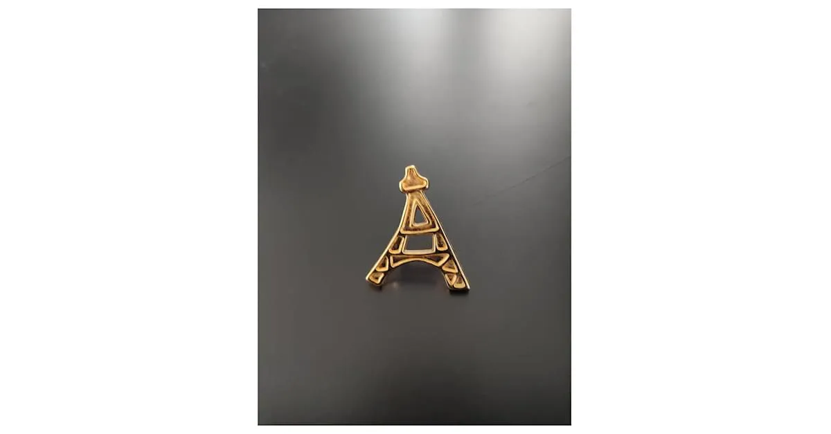 Yves Saint Laurent Alfileres y broches Dorado 